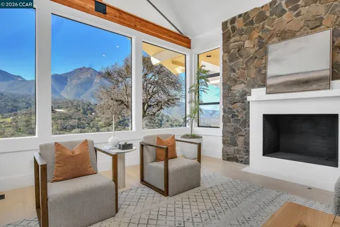 a kitchen with stainless steel appliances granite countertop a stove and a view of living room