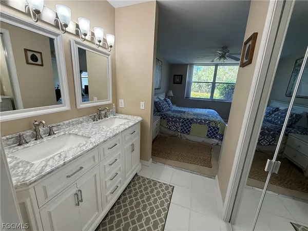 a bathroom with a double vanity sink and a mirror