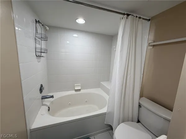 a bathroom with a sink a toilet a shower and a mirror