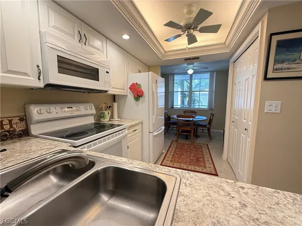 a view of a kitchen with a sink and cabinets
