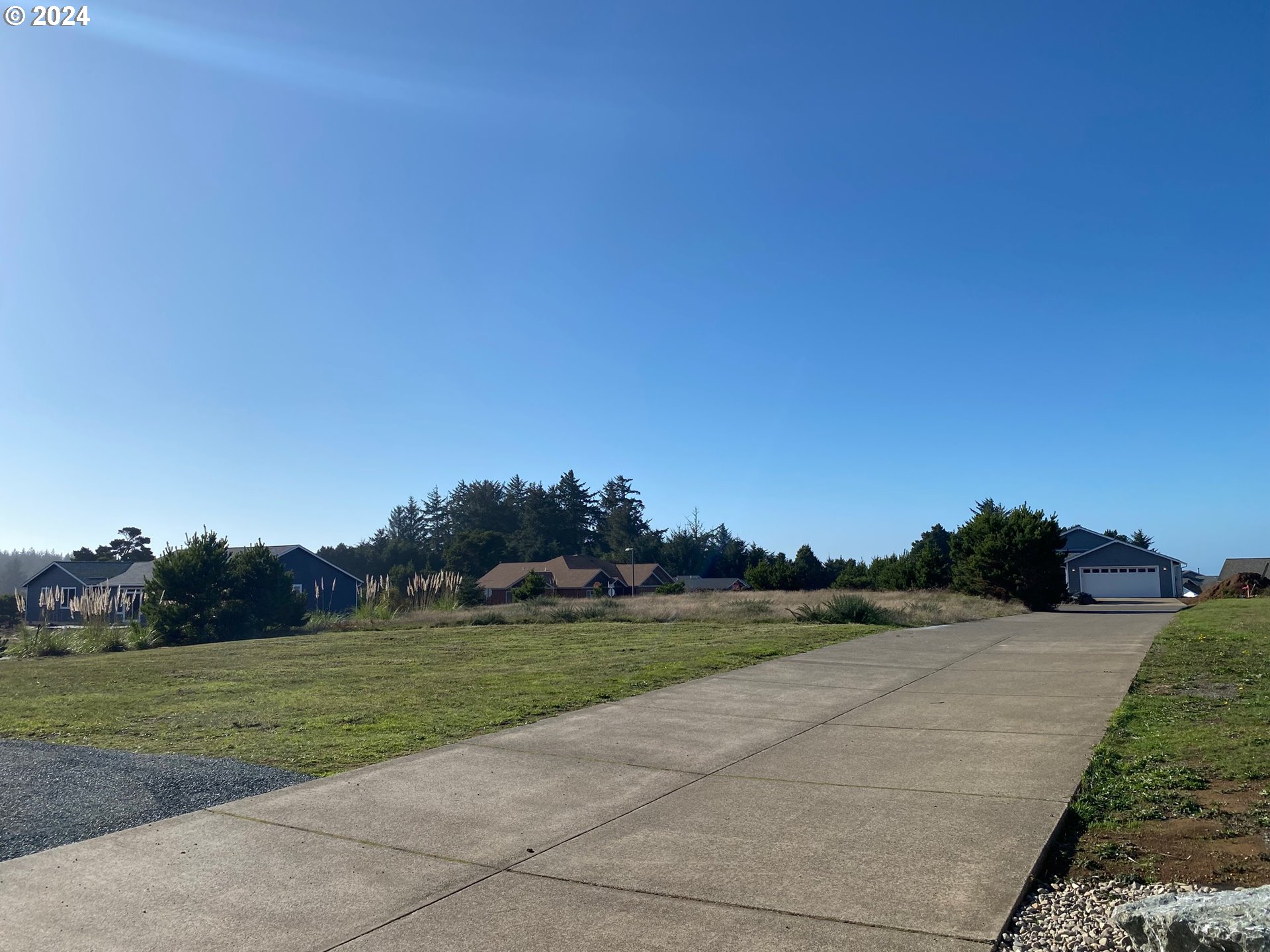 848 Seacrest Drive Bandon, OR 97411 - Photo 8 of 24 a view of a lake with a yard