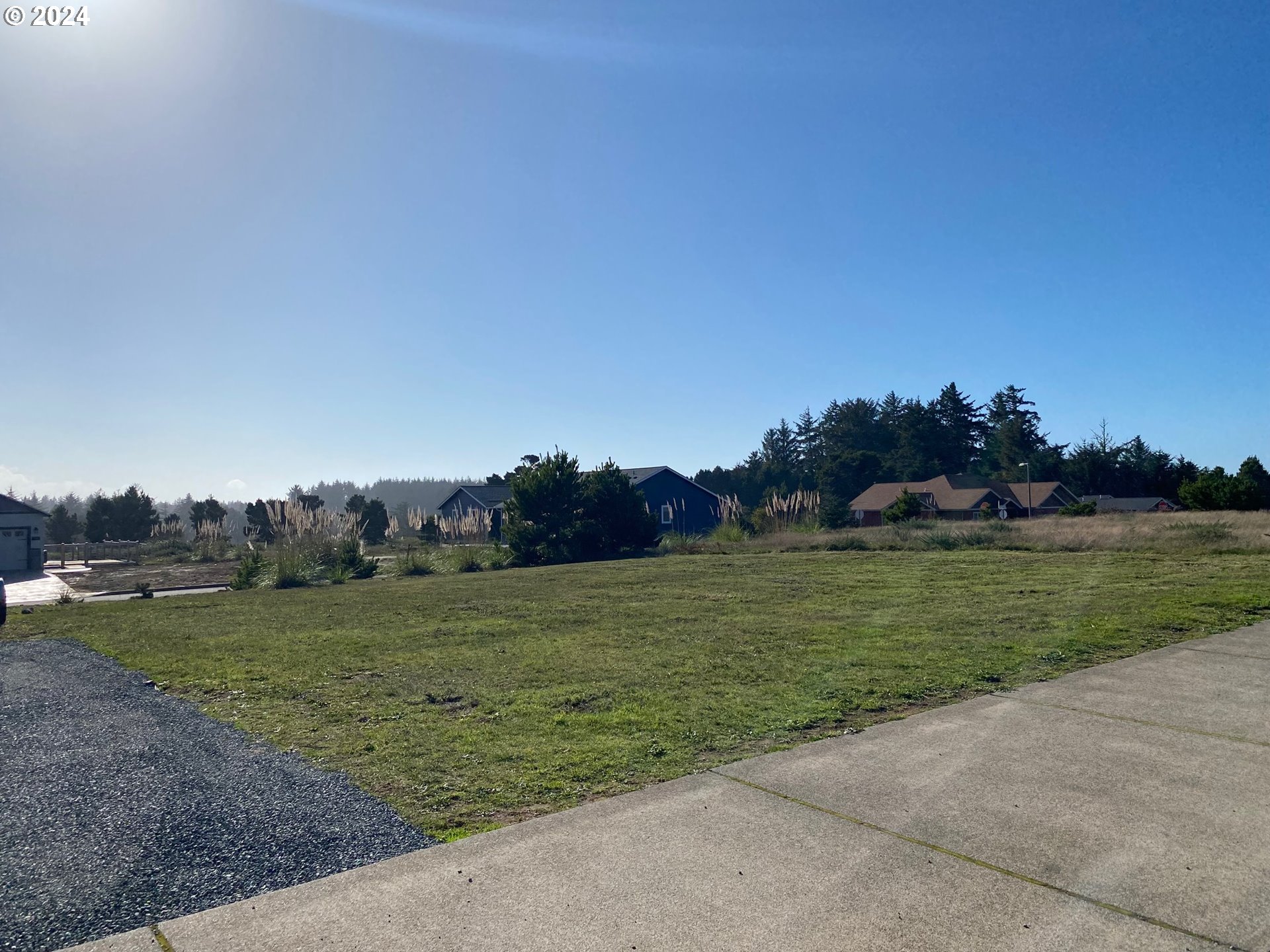 848 Seacrest Drive Bandon, OR 97411 - Photo 9 of 24 a view of a grassy field with an trees