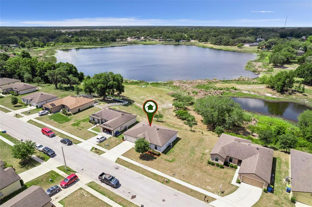 1613 Orne Street Mascotte, FL 34753 - Photo 27 of 31 an aerial view of multiple house with outdoor space and lake view