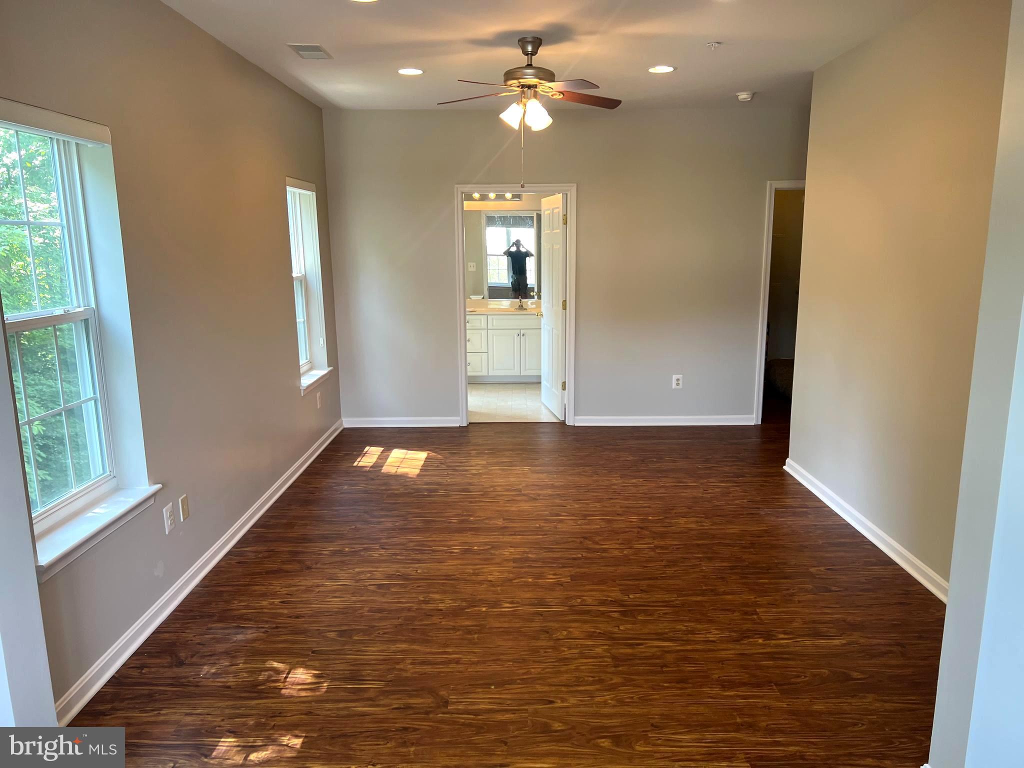431 Hopkins Landing Drive, Unit 431 Baltimore, MD 21221 - Photo 12 of 30 an empty room with wooden floor and windows