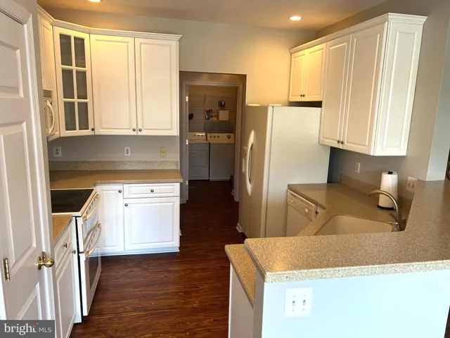 a kitchen with a stove a sink and a refrigerator