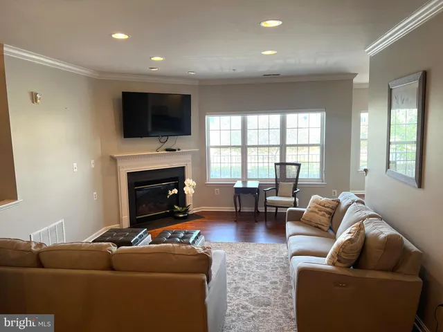 a living room with furniture window and a flat screen tv