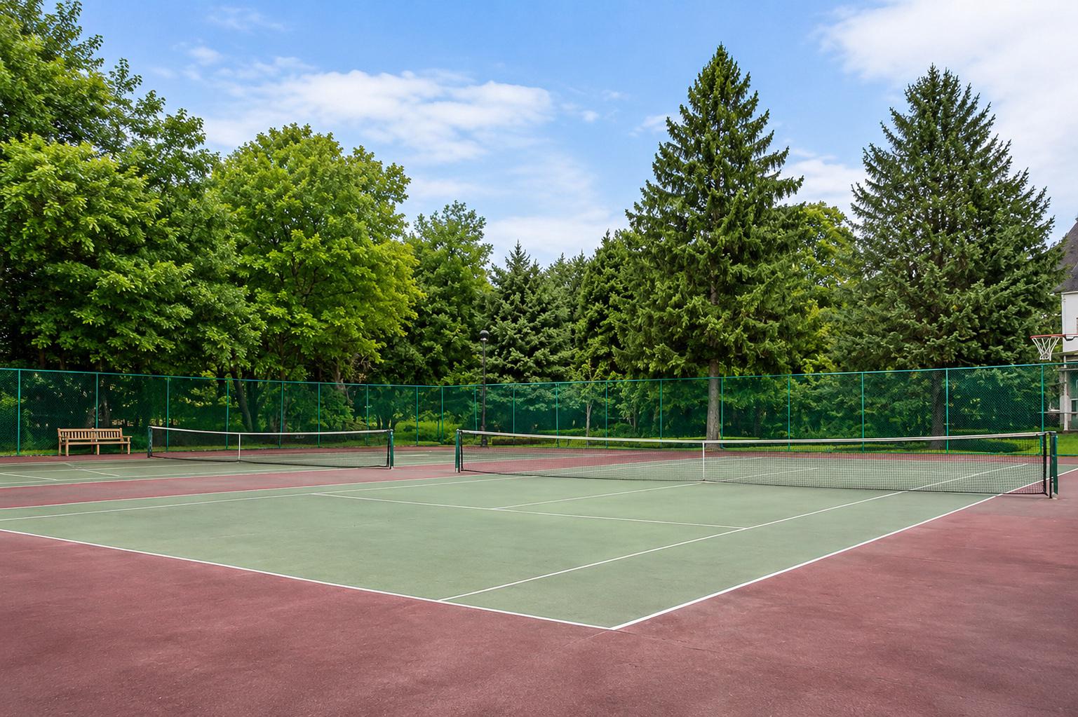 514 Old Forge Crossing Wayne, PA 19087 - Photo 17 of 17 Serene tennis court in lush greenery.