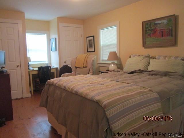 309 Schroon Hill Road Kerhonkson, NY 12446 - Photo 14 of 21 a bedroom with a bed and a painting on the wall
