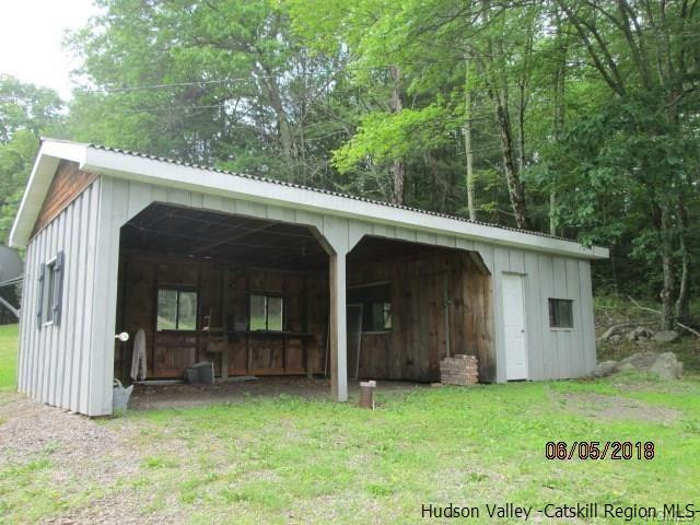 309 Schroon Hill Road Kerhonkson, NY 12446 - Photo 18 of 21 a view of a wooden house with large trees and a big yard