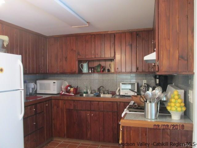 309 Schroon Hill Road Kerhonkson, NY 12446 - Photo 3 of 21 a kitchen with stainless steel appliances granite countertop wooden cabinets sink and stove