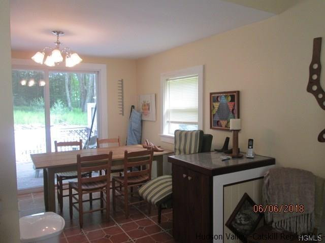 309 Schroon Hill Road Kerhonkson, NY 12446 - Photo 4 of 21 a dining room with furniture a window and a chandelier