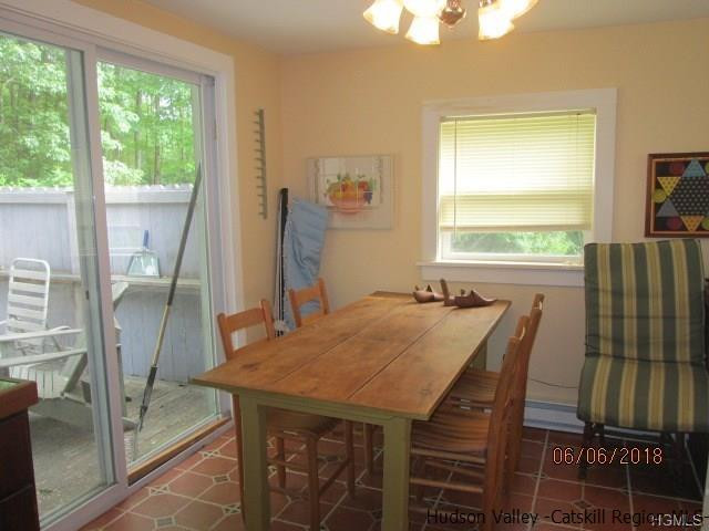 309 Schroon Hill Road Kerhonkson, NY 12446 - Photo 5 of 21 a view of a dining room with furniture window and outside view