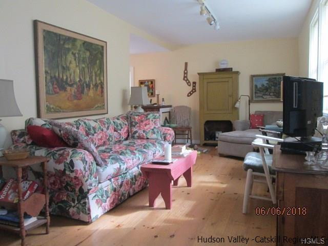 309 Schroon Hill Road Kerhonkson, NY 12446 - Photo 9 of 21 a living room with furniture a flat screen tv and a fireplace