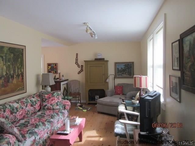 309 Schroon Hill Road Kerhonkson, NY 12446 - Photo 10 of 21 a living room with furniture fireplace and a flat screen tv