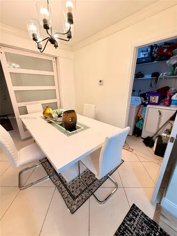 a living room with stainless steel appliances kitchen island furniture and a flat screen tv