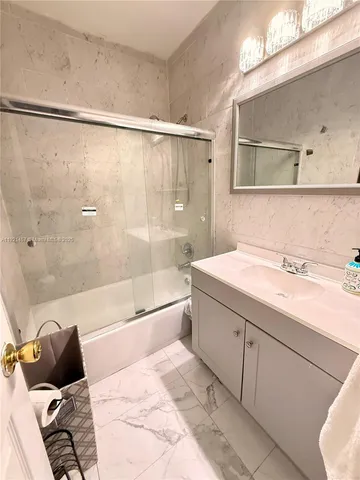 a bathroom with a sink mirror vanity and toilet
