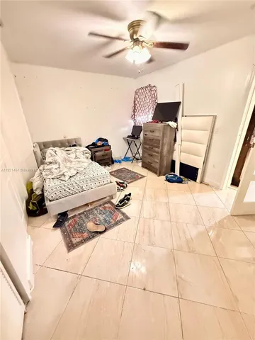 a bed room with a bed and a chair