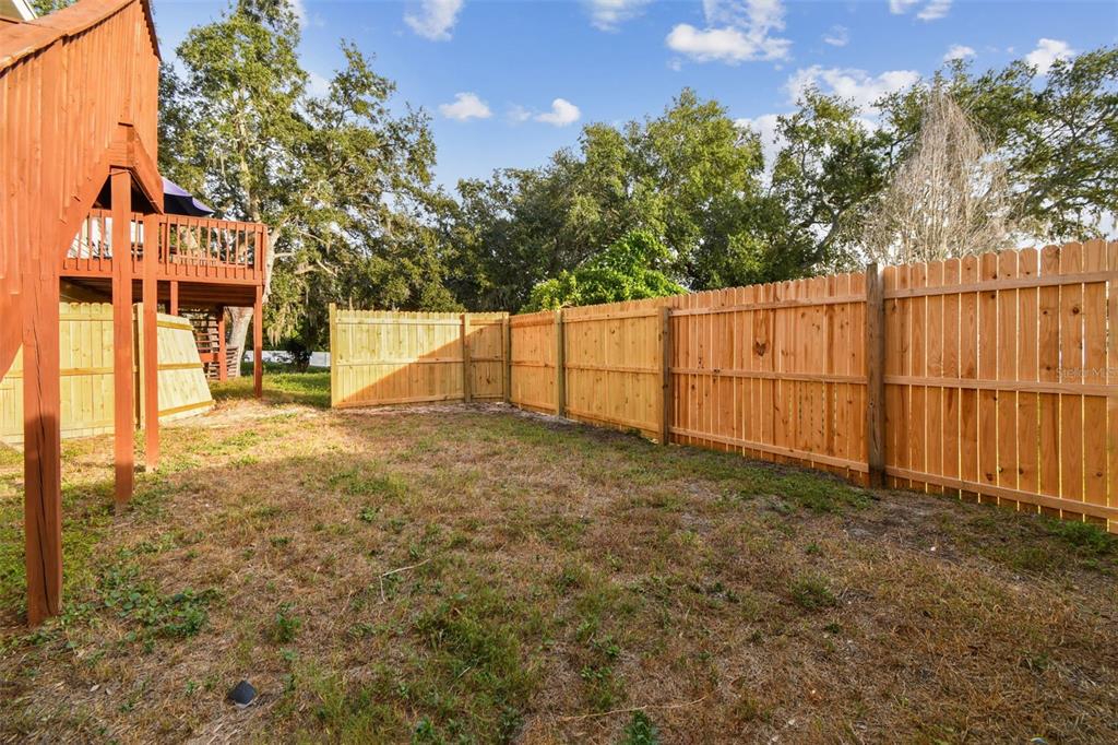 1734 Rumar Lane, Unit A Holiday, FL 34691 - Photo 31 of 100 a view of backyard with wooden fence