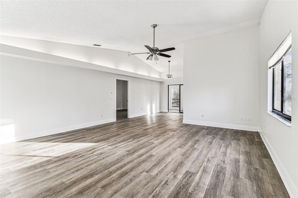 1734 Rumar Lane, Unit A Holiday, FL 34691 - Photo 36 of 100 a view of empty room with wooden floor and fan