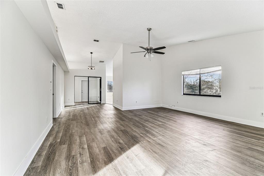 1734 Rumar Lane, Unit A Holiday, FL 34691 - Photo 39 of 100 wooden floor in an empty room with a window