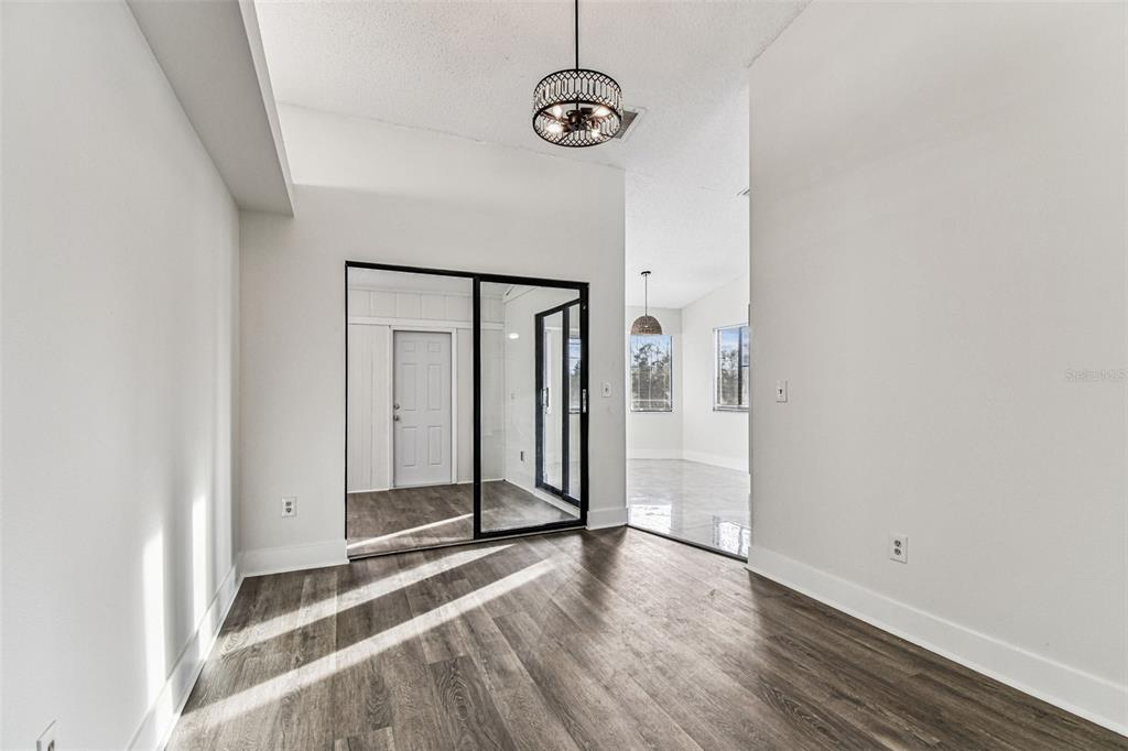 1734 Rumar Lane, Unit A Holiday, FL 34691 - Photo 40 of 100 a view of a livingroom with wooden floor and white walls