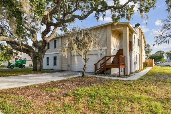 a view of a house with backyard and wooden fence