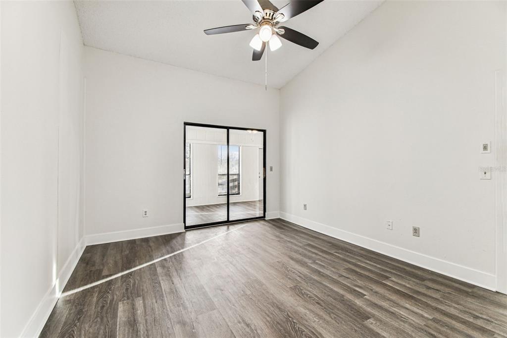 1734 Rumar Lane, Unit A Holiday, FL 34691 - Photo 60 of 100 an empty room with wooden floor closet and fan