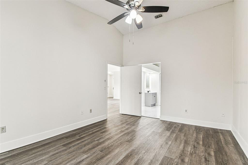 1734 Rumar Lane, Unit A Holiday, FL 34691 - Photo 61 of 100 an empty room with wooden floor fan and windows