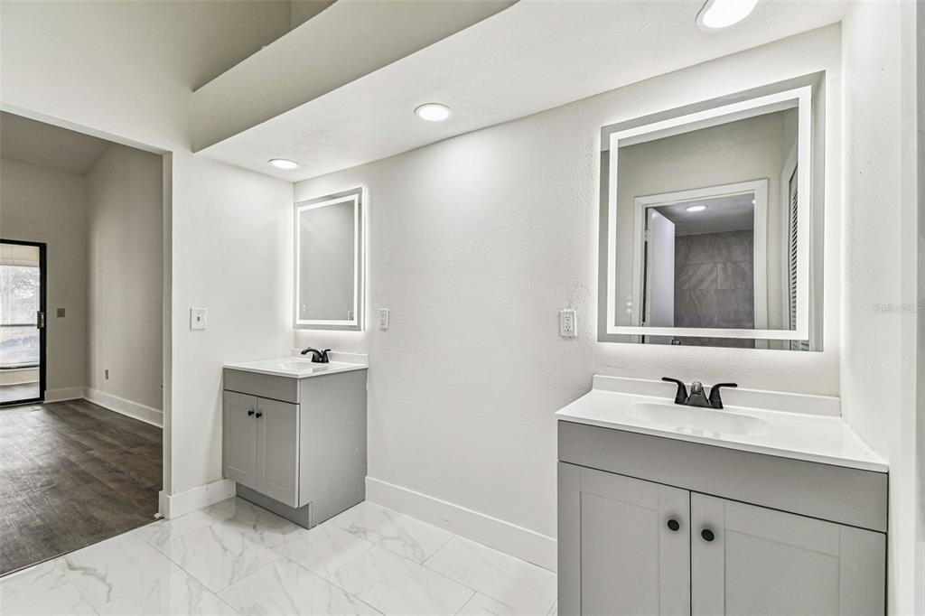 1734 Rumar Lane, Unit A Holiday, FL 34691 - Photo 64 of 100 a bathroom with a sink and a mirror