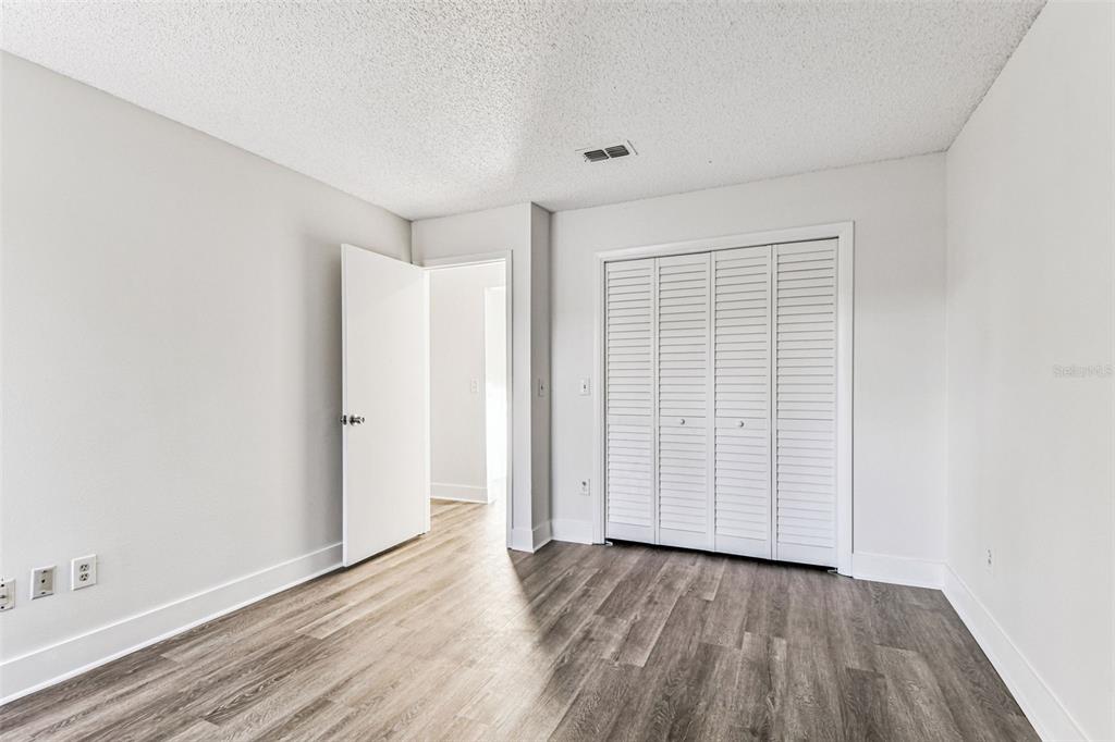 1734 Rumar Lane, Unit A Holiday, FL 34691 - Photo 70 of 100 an empty room with wooden floor and closet area