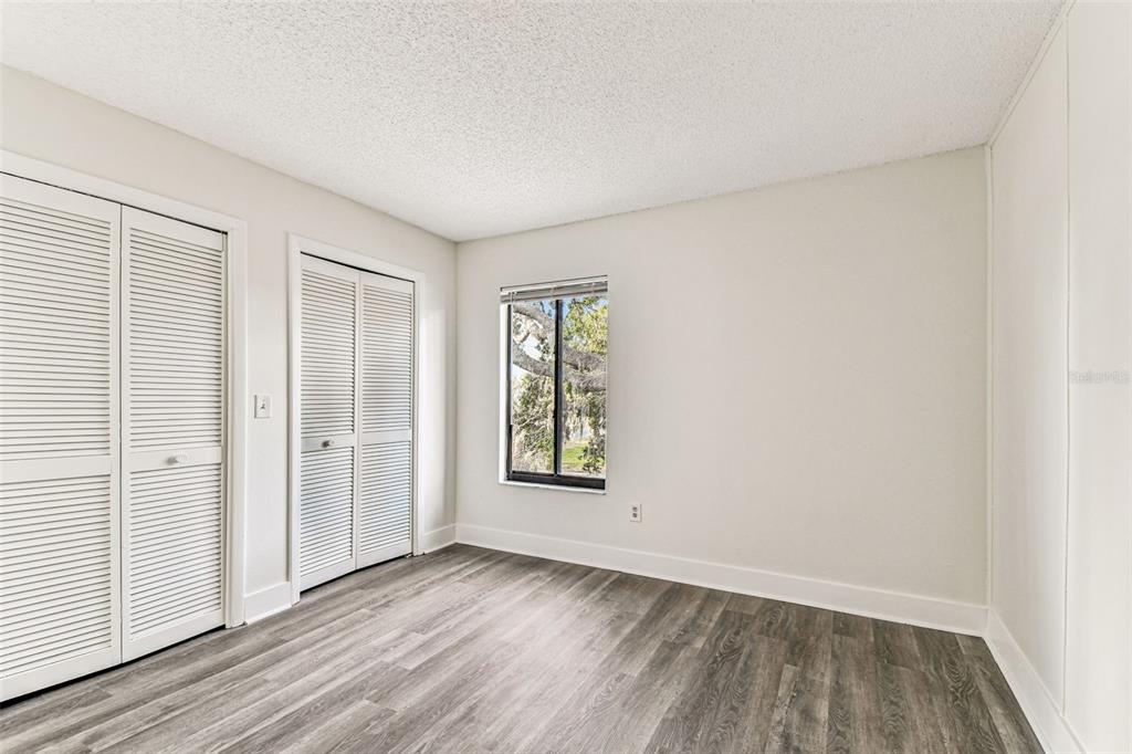 1734 Rumar Lane, Unit A Holiday, FL 34691 - Photo 76 of 100 an empty room with wooden floor and windows