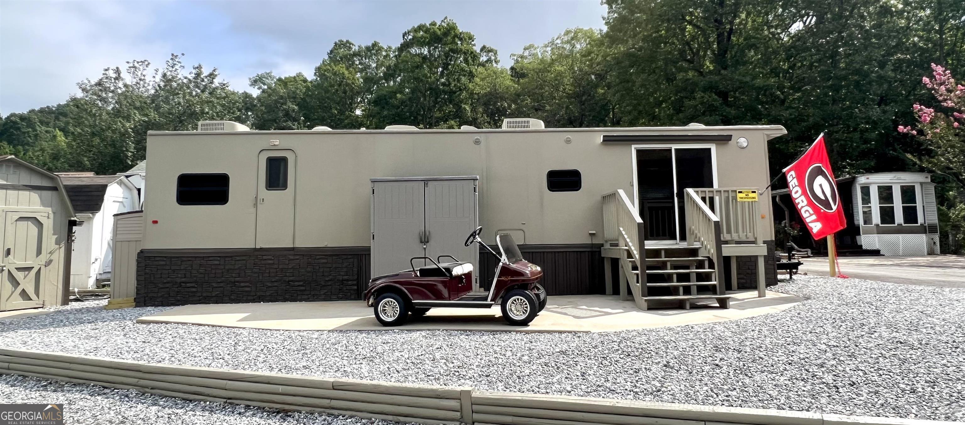 a view of house with swimming pool and furniture
