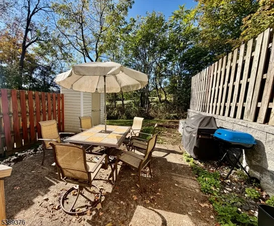 a backyard of a house with table and chairs