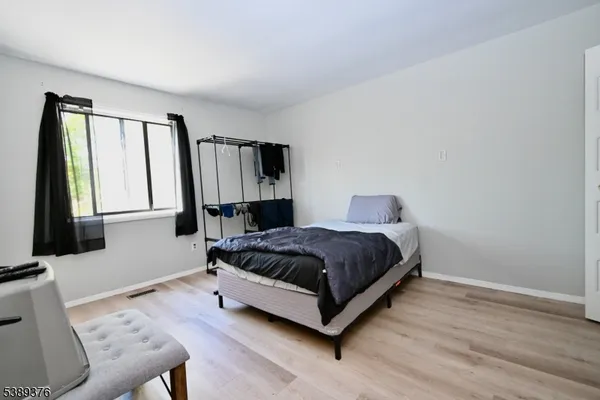 a bedroom with a bed lamp and a window