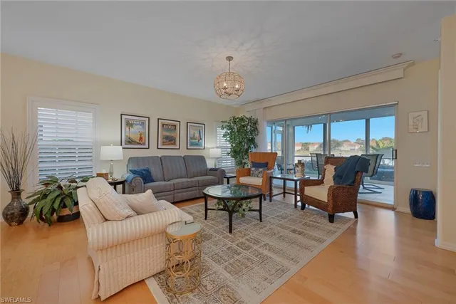 a living room with furniture wooden floor and a table