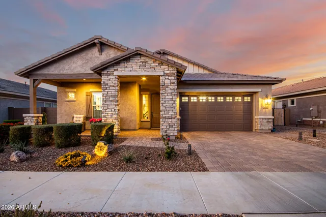 a front view of a house with basket ball court and a garage