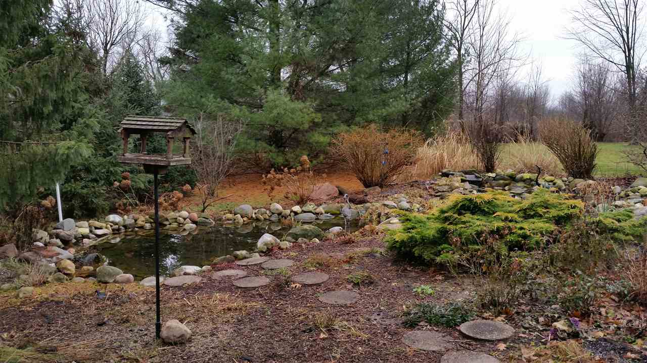 353 Cummings Road Caledonia, IL 61011 - Photo 21 of 24 a backyard of a house with a yard and outdoor seating