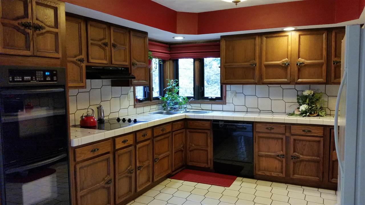 353 Cummings Road Caledonia, IL 61011 - Photo 4 of 24 a kitchen with stainless steel appliances granite countertop a sink stove and cabinets