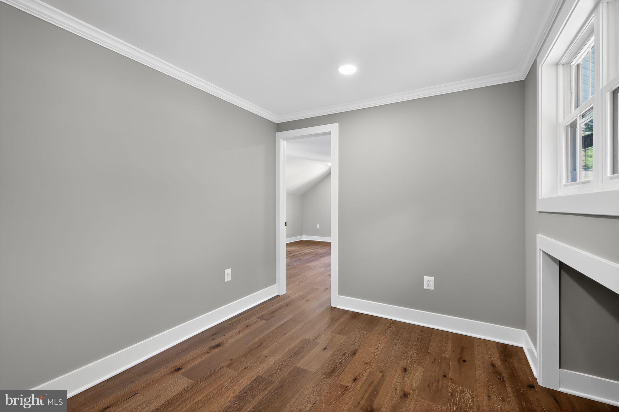 1 Tucker Street Annapolis, MD 21401 - Photo 16 of 46 a view of an empty room with wooden floor and a window