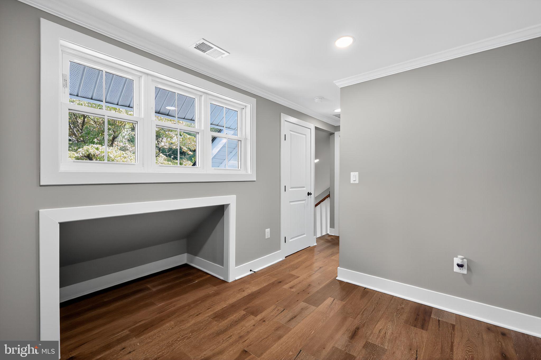 1 Tucker Street Annapolis, MD 21401 - Photo 19 of 46 a view of an empty room with wooden floor and a window