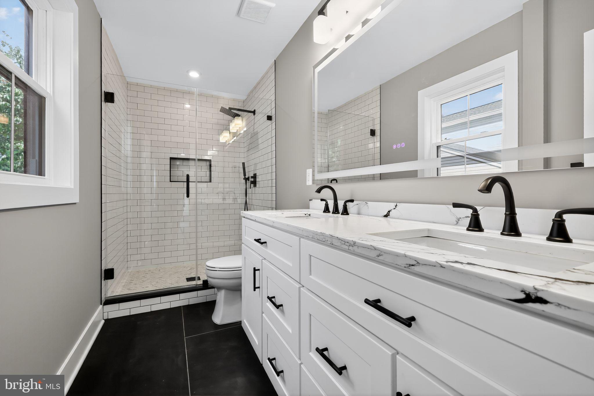 1 Tucker Street Annapolis, MD 21401 - Photo 22 of 46 a bathroom with a double vanity sink a toilet and a window