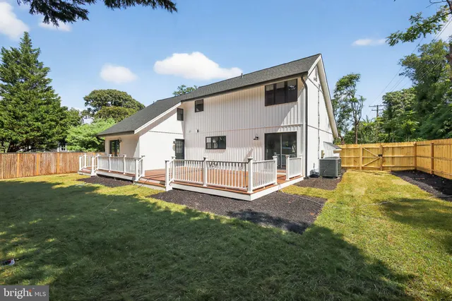 a view of a house with a yard and a patio