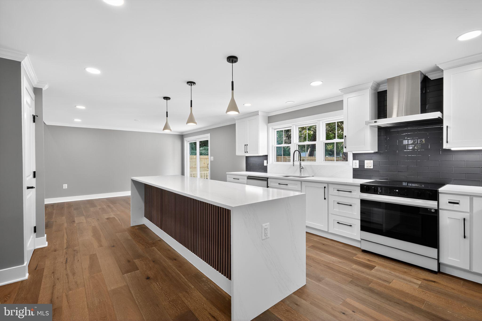 1 Tucker Street Annapolis, MD 21401 - Photo 8 of 46 a kitchen with stainless steel appliances granite countertop a sink stove and cabinets