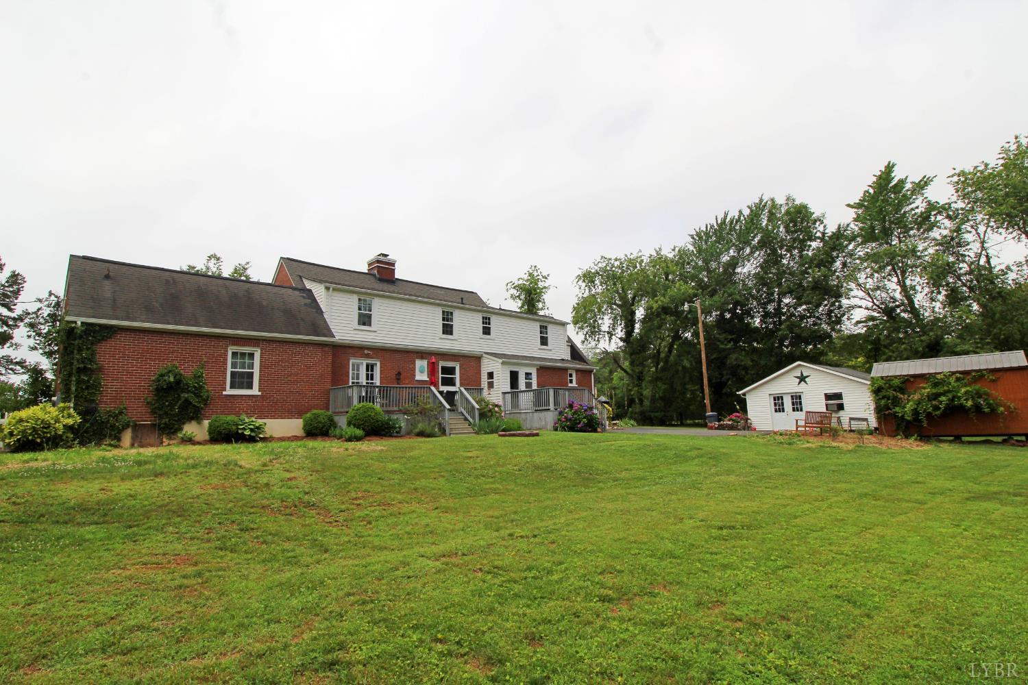 1538 Redfields Road Appomattox, VA 24522 - Photo 12 of 60 a view of a house with a big yard and large trees