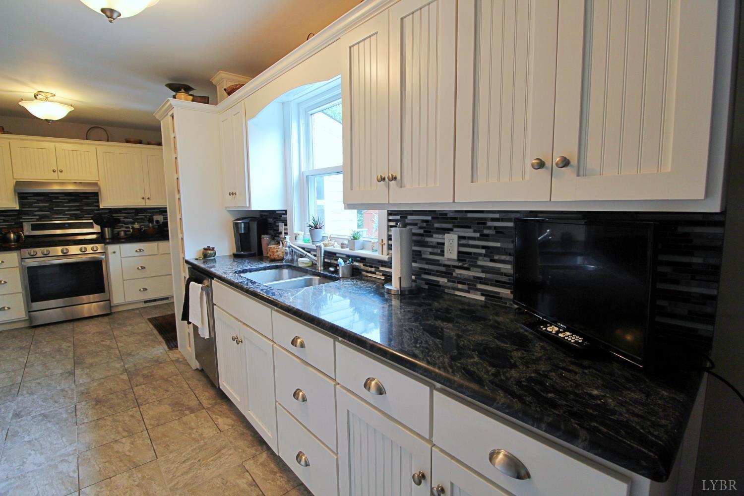 1538 Redfields Road Appomattox, VA 24522 - Photo 18 of 60 a kitchen with stainless steel appliances granite countertop a stove a sink and a microwave