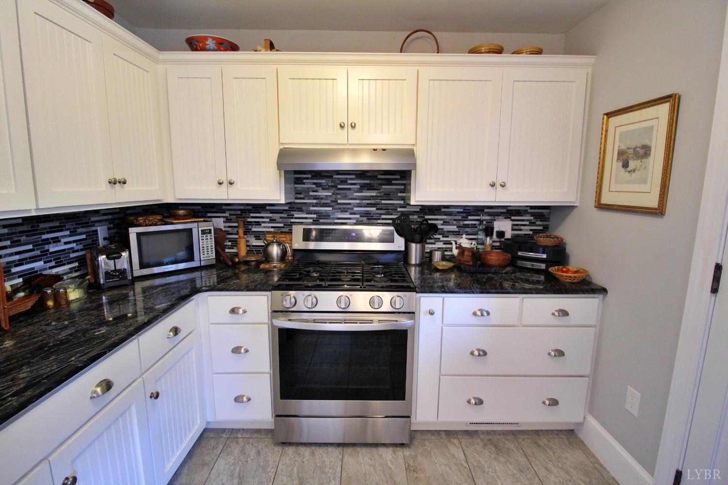 1538 Redfields Road Appomattox, VA 24522 - Photo 21 of 60 a kitchen with granite countertop white cabinets and stainless steel appliances