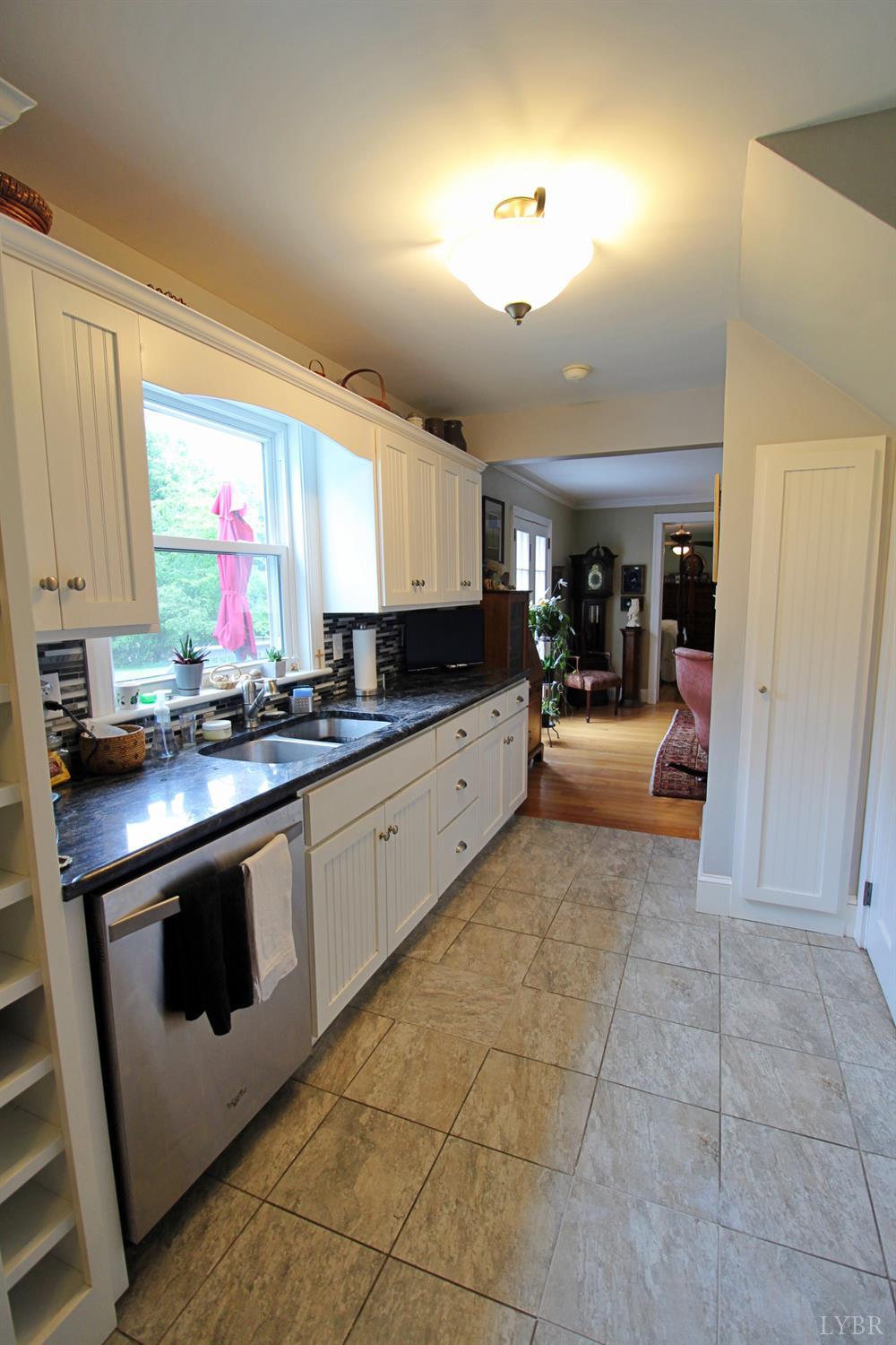 1538 Redfields Road Appomattox, VA 24522 - Photo 25 of 60 a kitchen with stainless steel appliances granite countertop a stove a sink and a microwave