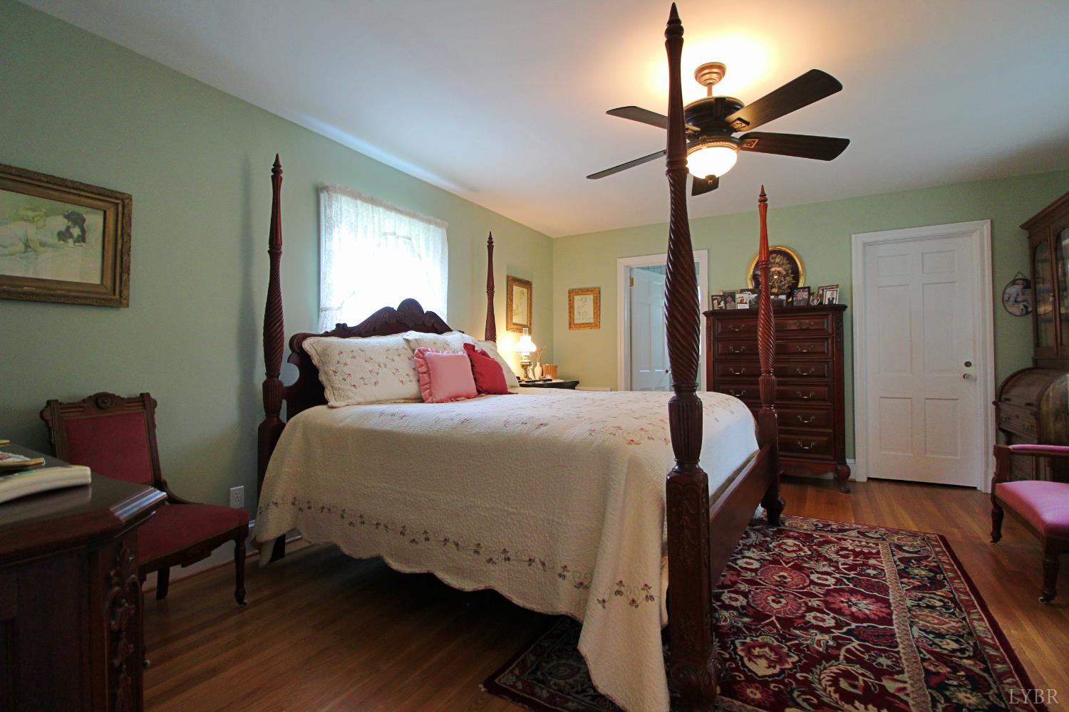 1538 Redfields Road Appomattox, VA 24522 - Photo 33 of 60 a bedroom with a bed and wooden floor