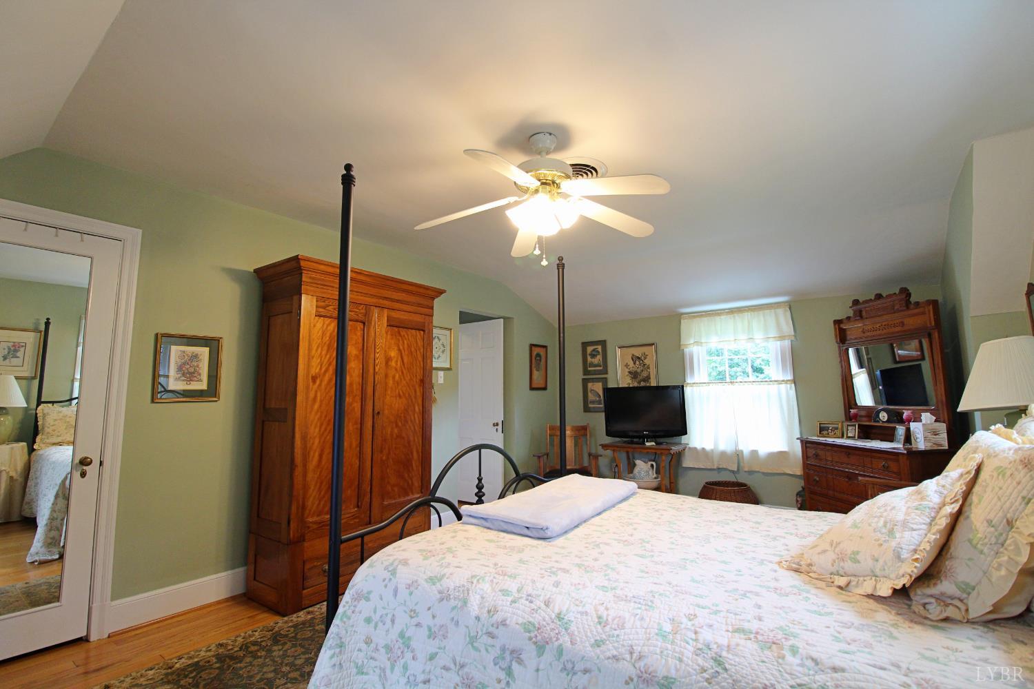 1538 Redfields Road Appomattox, VA 24522 - Photo 41 of 60 a bedroom with a bed chandelier and a window