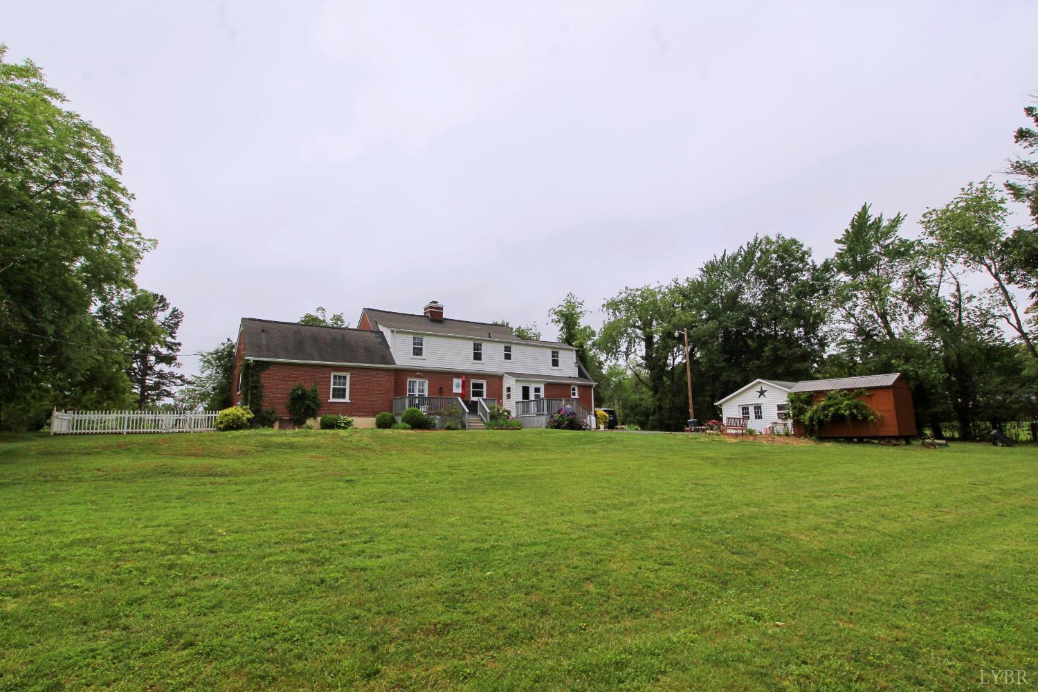 1538 Redfields Road Appomattox, VA 24522 - Photo 59 of 60 a view of a big house with a big yard and large trees